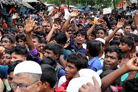 Rohingya refugees shout slogans as they take part in a protest