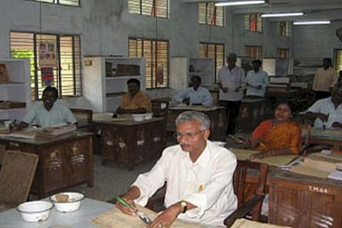 An expert preserving records at Archives and Historical Research department of State government