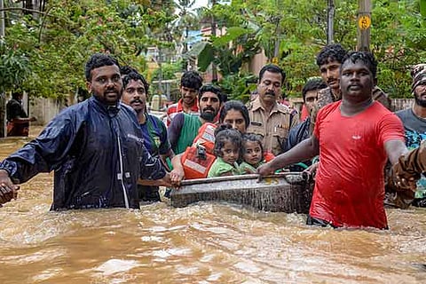 Rescuers evacuate people from a flood-hit locality, in Thiruvananthapuram.