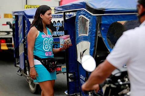 A Venezuelan migrant sells candy at a street in Tumbes