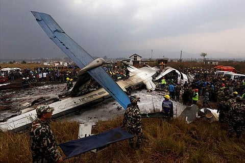 File photo of rescue workers work at the wreckage of a US-Bangla airplane after it crashed