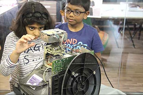 Kids try their hand at a dismantling exercise