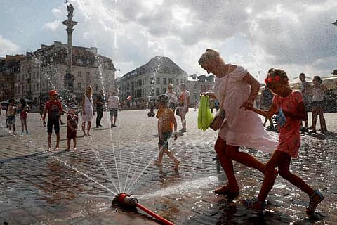 People cool off in the water during a hot summer day in Warsaw