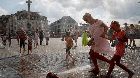People cool off in the water during a hot summer day in Warsaw