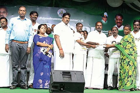 Minister RB Udayakumar handing over welfare measure to a beneficiary in Tiruvannamalai