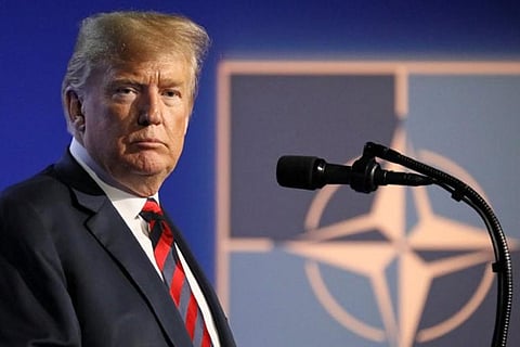 Trump attacks Paris climate agreement, cites France protests