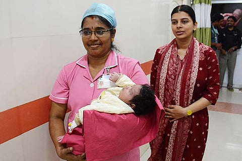 The baby with the mother (right)