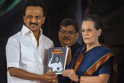 Former Congress President Sonia Gandhi handing souvenir to DMK president MK Stalin