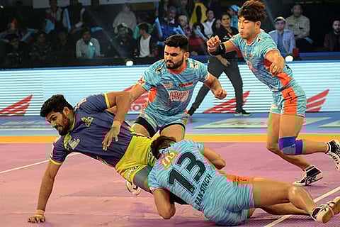 Thalaivas raider MS Athul tries to escape from three defenders