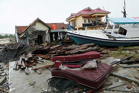 Debris and damaged properties are seen after tsunami attack in Indonesia