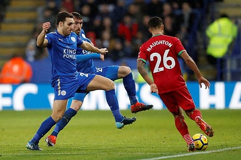 Swansea City's Kyle Naughton in action with Leicester City's Matty James and Christian Fuchs