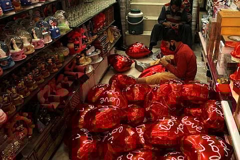 Men inflate heart shaped balloons ahead of Valentine's day in Peshawar, Pakistan