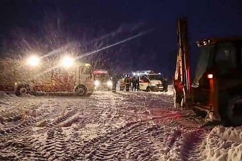 Russian first responders work at the scene of a AN-148 plane crash