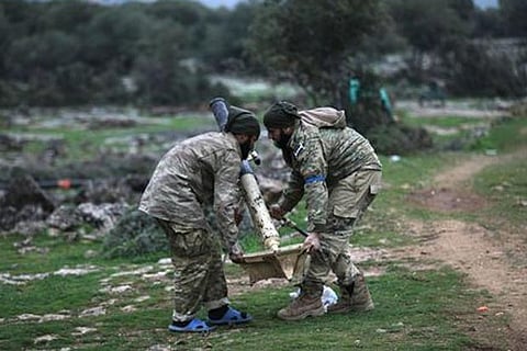 Turkish-backed Free Syrian Army fighters hold a mortar outside of Afrin