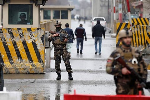Afghan security forces keep watch at a check point near the site of a suicide attack in Kabul