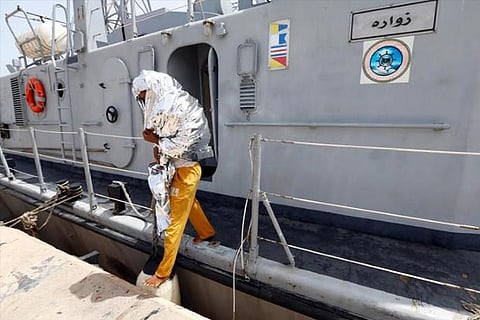 A migrant arrives at a naval base after being rescued by Libyan coast guards in Tripoli