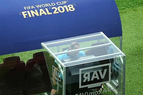 Referee Nestor Pitana checks VAR before the penalty is awarded