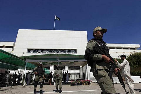 File photo of paramilitary soldiers walk past the Parliament building in Islamabad