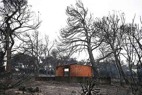 A burned house is seen following a wildfire at the village of Mati, near Athens, Greece
