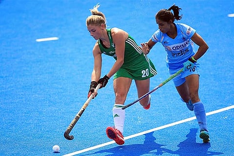 India's Vandana Katariya, right, and Ireland's Chloe Watkins in action