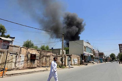 Smoke rises from an area where explosions and gunshots were heard, in Jalalabad city