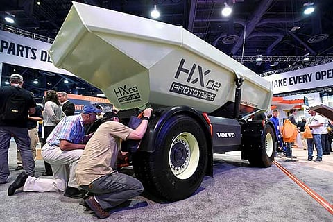 Attendees examine Volvo HX02, an e-autonomous dump truck at a convention centre in Las Vegas