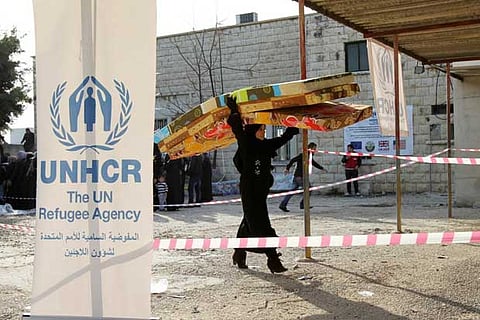 A Syrian refugee receives aid from the UN refugee agency (UNHCR) in Batroun, northern Lebanon