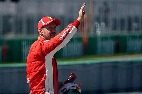 Ferrari?s Sebastian Vettel celebrates qualifying in pole position