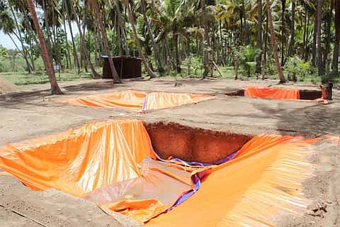 Trenches covered by plastic sheets following heavy rain at the Keezhadi archaeological site
