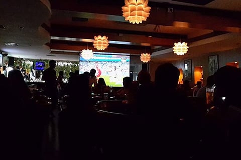 Patrons enjoy a match screening at a popular restobar in the city