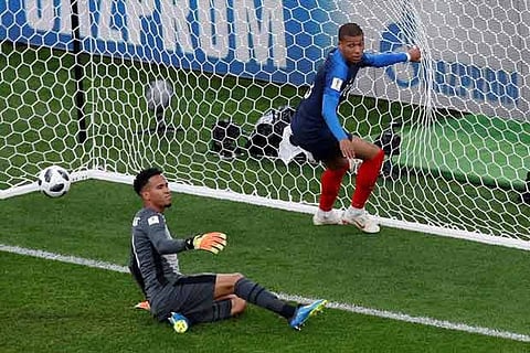 Peru's Pedro Gallese looks dejected as France's Kylian Mbappe celebrates scoring their first goal