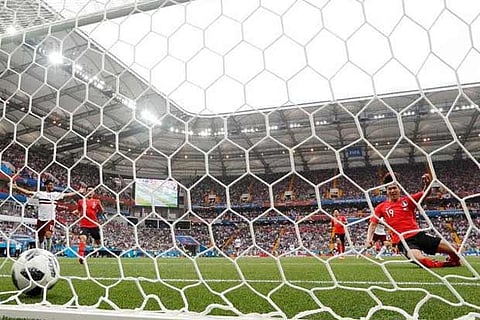 South Korean players look dejected as Mexico's Carlos Vela celebrates the second goal