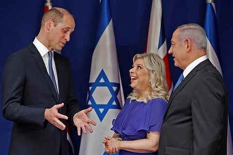 Britain's Prince William gestures as he speaks with Israeli PM Benjamin Netanyahu and his wife Sara