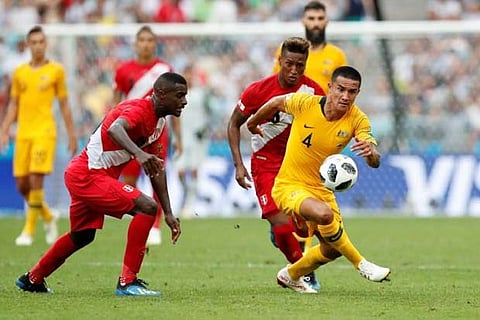 Australia's Tim Cahill in action with Peru's Pedro Aquino and Christian Ramos