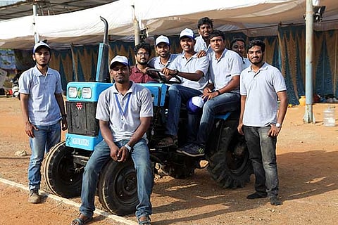 Students with a tractor designed by them at the Tractor Design Competition
