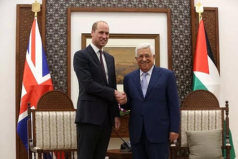 Palestinian President Mahmoud Abbas shakes hands with Britain's Prince William