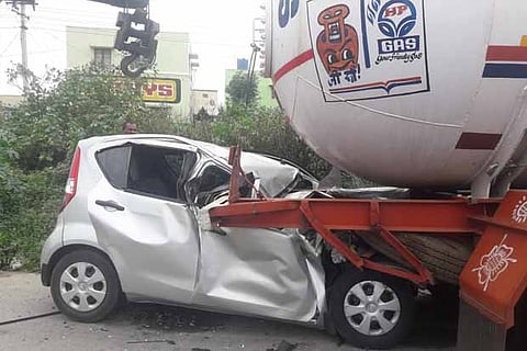 The mangled remains of a car which crashed into a tanker lorry in Krishnagiri district
