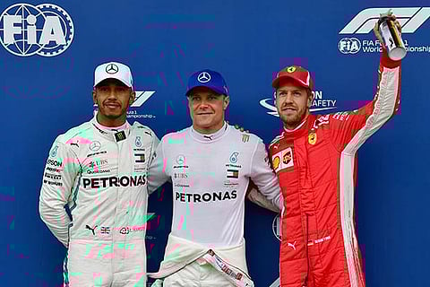 Valtteri Bottas (centre) is flanked by Lewis Hamilton (left) and Sebastian Vettel