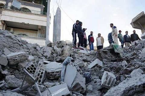 Residents inspect a damaged site
