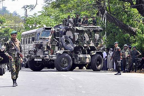 Sri Lankan police commandos patrol on the streets of Pallekele, a suburb of Kandy
