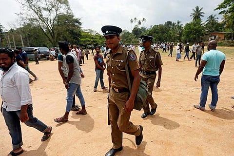Police officers leave after providing security for friday prayers after a mosque burned down