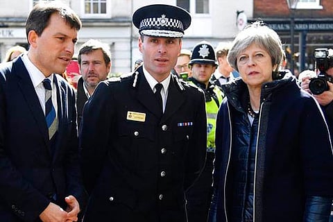 PM Theresa May (R) views the area where former Russian double agent Sergei Skripal and his daughter were found