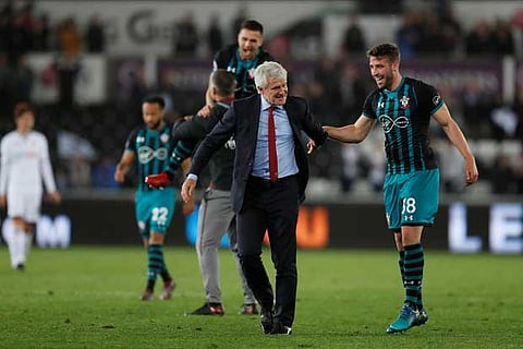 Southampton manager Mark Hughes celebrates after the match with Sam McQueen
