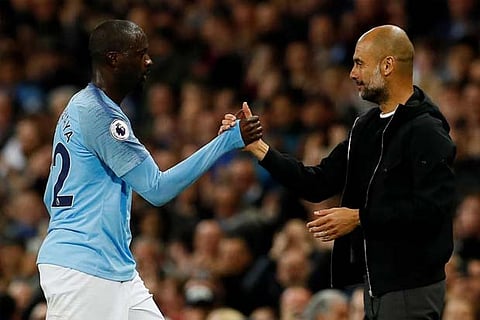 Manchester City's Yaya Toure is substituted off as Manchester City manager Pep Guardiola looks on.