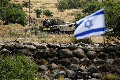 An Israeli tank can be seen near the Israeli side of the border with Syria