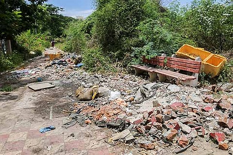Garbage dumped on parts of the path around the benches, making it unusable for public
