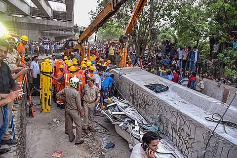 Crushed vehicles after a portion of an under-construction flyover collapsed in Varanasi