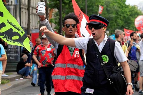 Protesters shout slogans during a demonstration by French unions