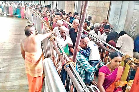 Devotees stand in queue to have a darshan of the deity at the Samayapuram temple