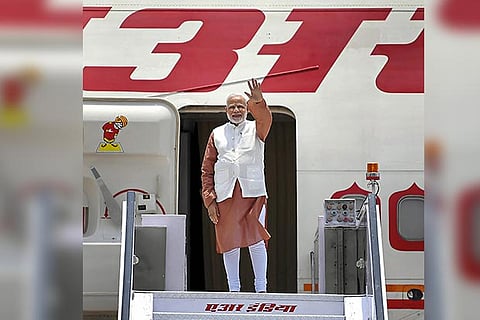 PM Narendra Modi waves as he emplanes for his visit to Indonesia, Malaysia and Singapore